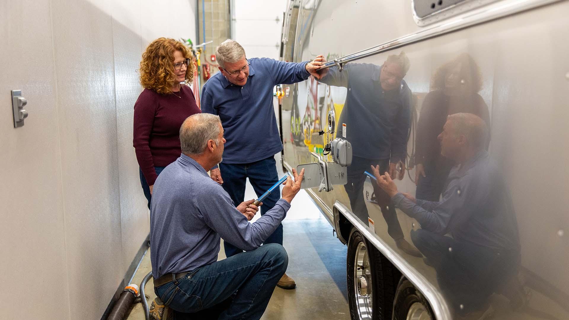 Airstream specialist guiding two owners through their travel trailer systems